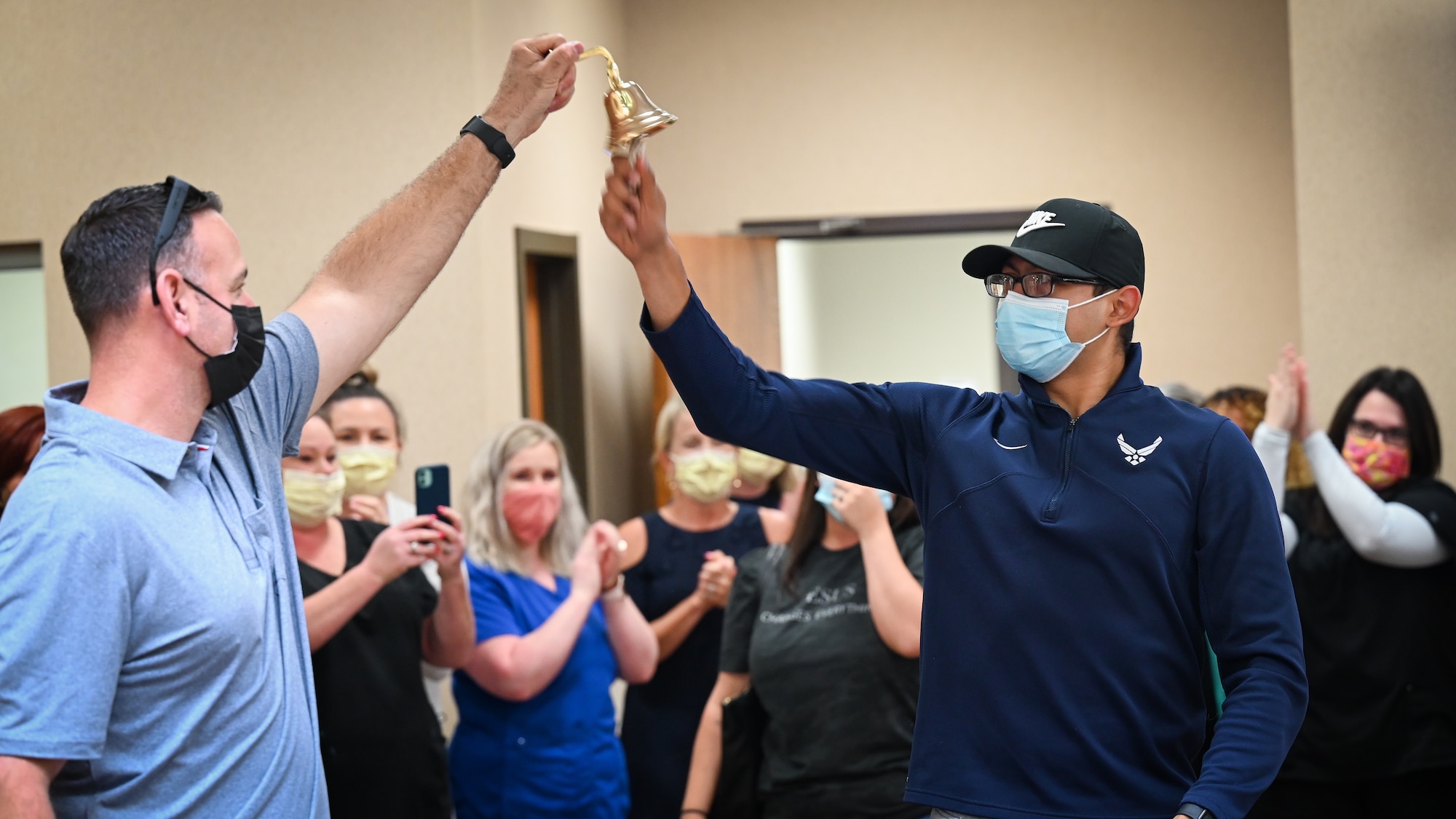 Senior Airman Eleazar Hernandez, 2nd Maintenance Squadron aerospace ground equipment journeyman, rings a bell after his final chemotherapy treatment at the CHRISTUS Health Shreveport-Bossier medical center, Louisiana, July 2, 2021. The bell signals the end of chemotherapy treatment and a warm tradition among cancer patients completing radiation treatments. (U.S. Air Force photo by Airman 1st Class Jonathan E. Ramos)