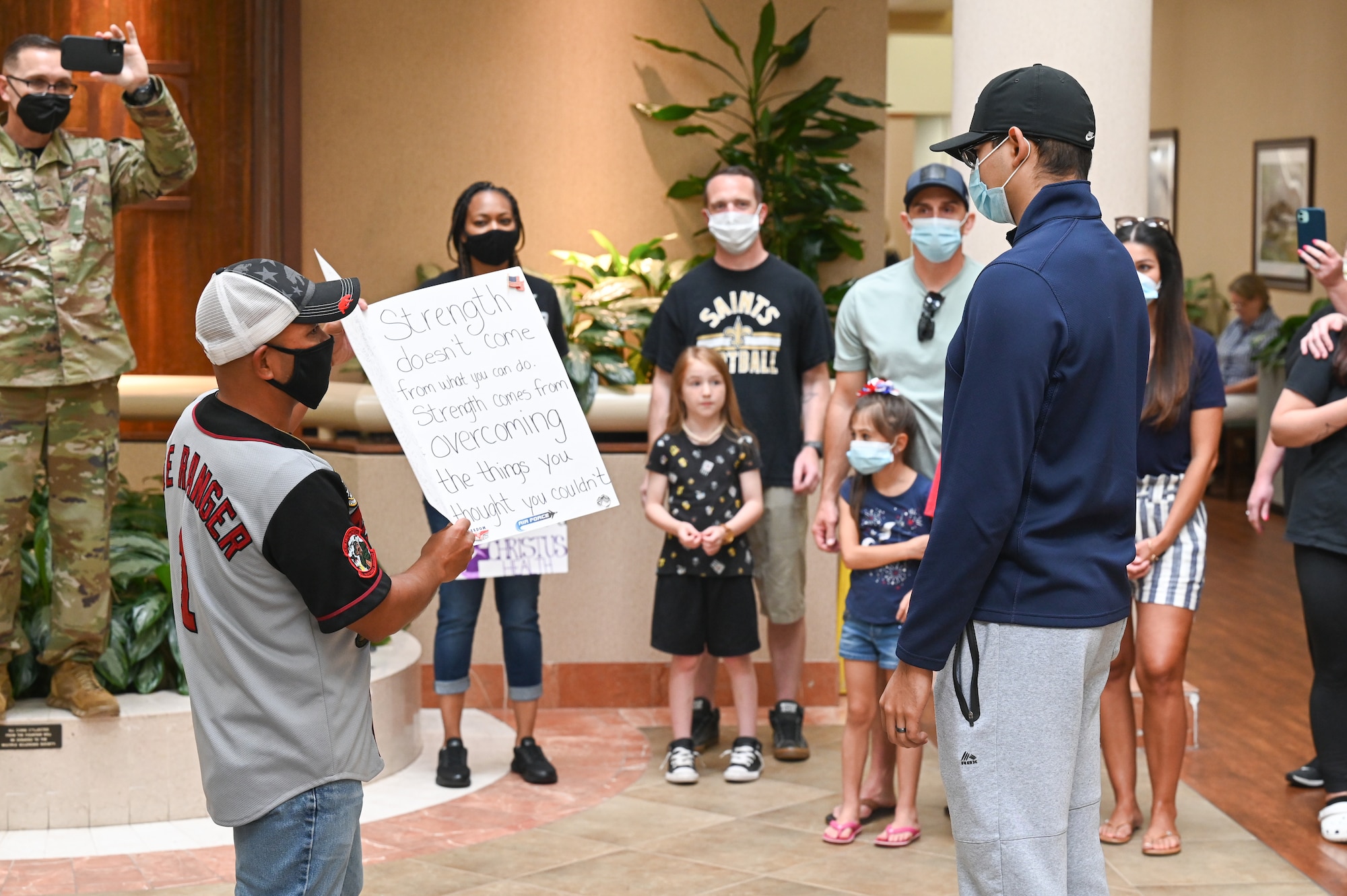 Senior Airman Eleazar Hernandez, 2nd Maintenance Squadron aerospace ground equipment journeyman, receives a morale gift after his final chemotherapy treatment at the CHRISTUS Health Shreveport-Bossier medical center, Louisiana, July 2, 2021. Hernandez fought cancer for 6 months before entering remission. (U.S. Air Force photo by Airman 1st Class Jonathan E. Ramos)