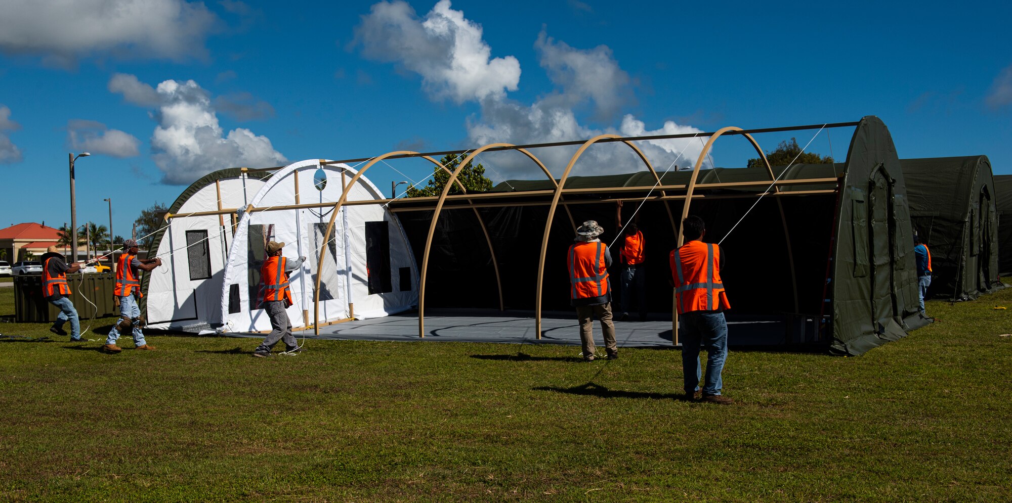 Contractors construct tents in preparation of Exercise Forager 21 on Andersen Air Force Base, Guam, June 24, 2021. Soldiers from Alaska, Arizona, Hawaii, Virginia, Texas, and Washington state traveled to AAFB to participate in Exercise Forager 21. (U.S. Air Force photo by Senior Airman Michael S. Murphy)