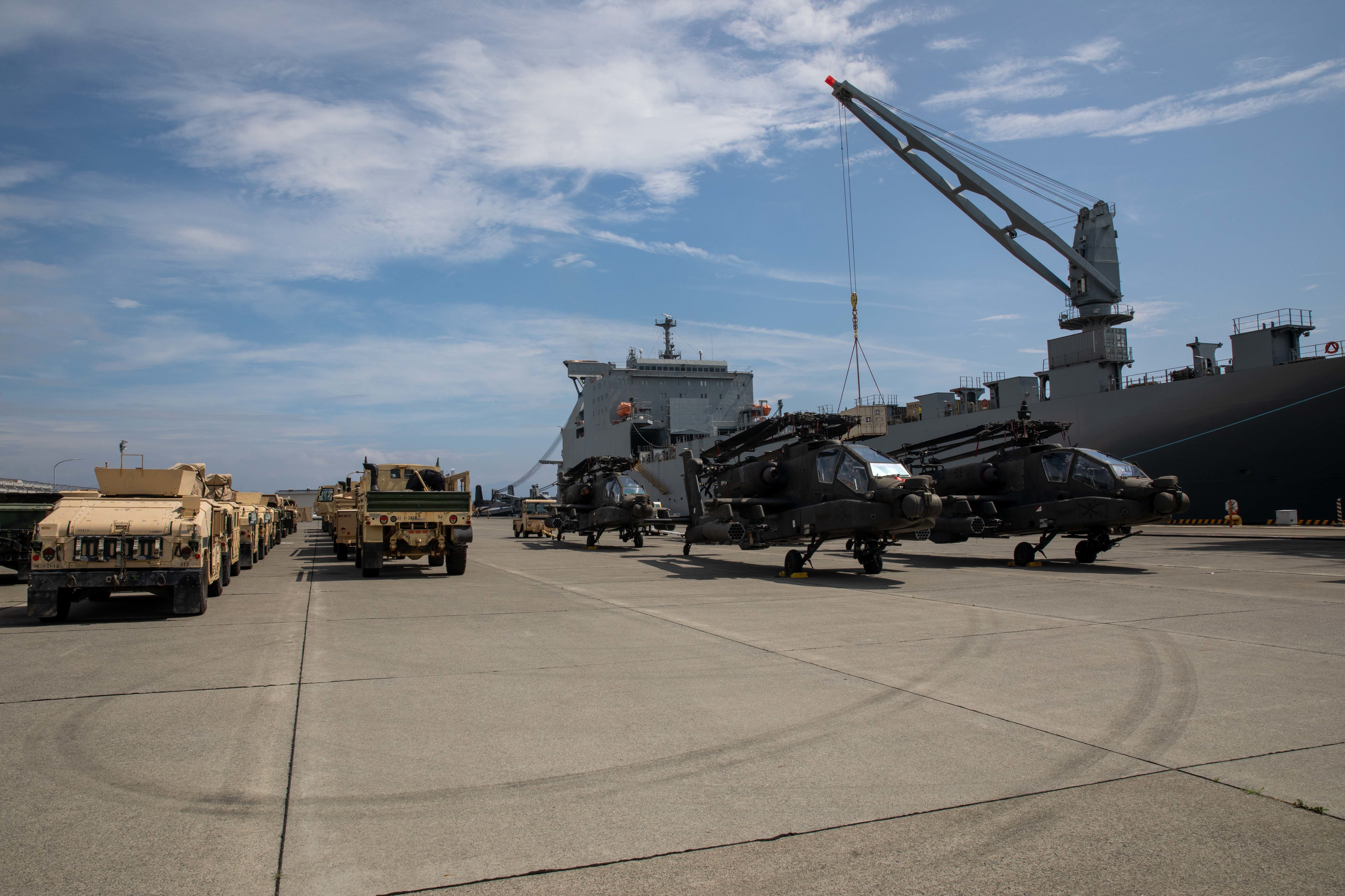Personnel with the 836th Transport Battalion, Surface Deployment and Distribution Command (SDDC), load cargo onto the USNS Fisher.