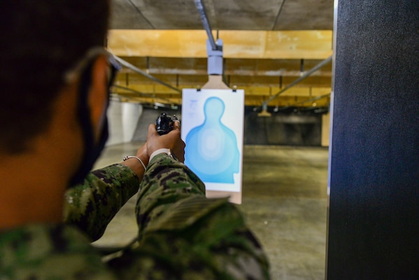Personnel Specialist Seaman Brittany Bracley, a Selected Reservist Sailor assigned to Navy Reserve Naval Security Forces Fort Worth, aims her service pistol in preparation to fire at a target during a weapons qualification exercise held at the small arms range aboard Naval Air Station Fort Worth Joint Reserve Base. The exercise is part of a  Navy-wide sustainment training requirement for all Sailors designated as armed watch standers. (U.S. Navy photo by Mass Communication Specialist 1st Class Lawrence Davis)