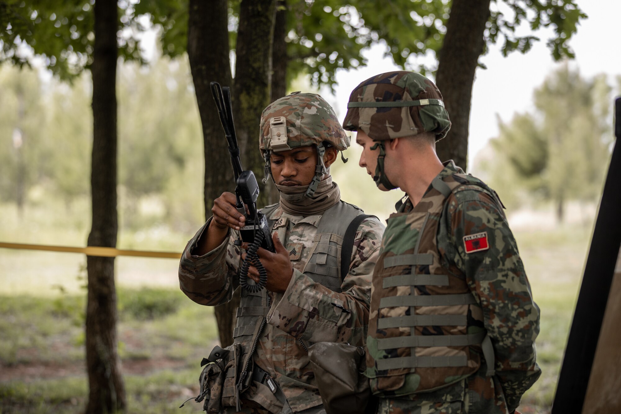 A Florida Army National Guard Soldier shows an Albanian cadet how to program a radio during DEFENDER-Europe 21-linked exercise Immediate Response May 18, 2021.
