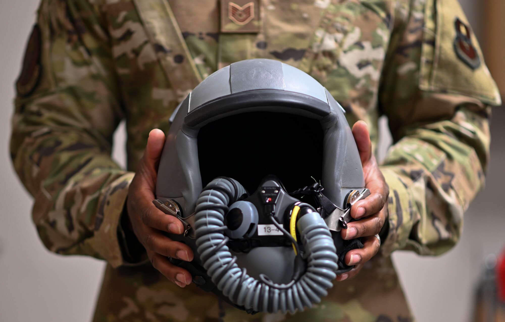 Tech. Sgt. Teddrick Thibodeaux, 14th Operations Support Squadron Aircrew Flight Equipment (AFE) flight chief, holds an aircrew flight helmet, July 22, 2021, on Columbus Air Force Base, Miss. Aircrew Flight Equipment is responsible for ensuring that all flight and safety equipment is in perfect working order. (U.S. Air Force photo by Airman 1st Class Jessica Haynie)