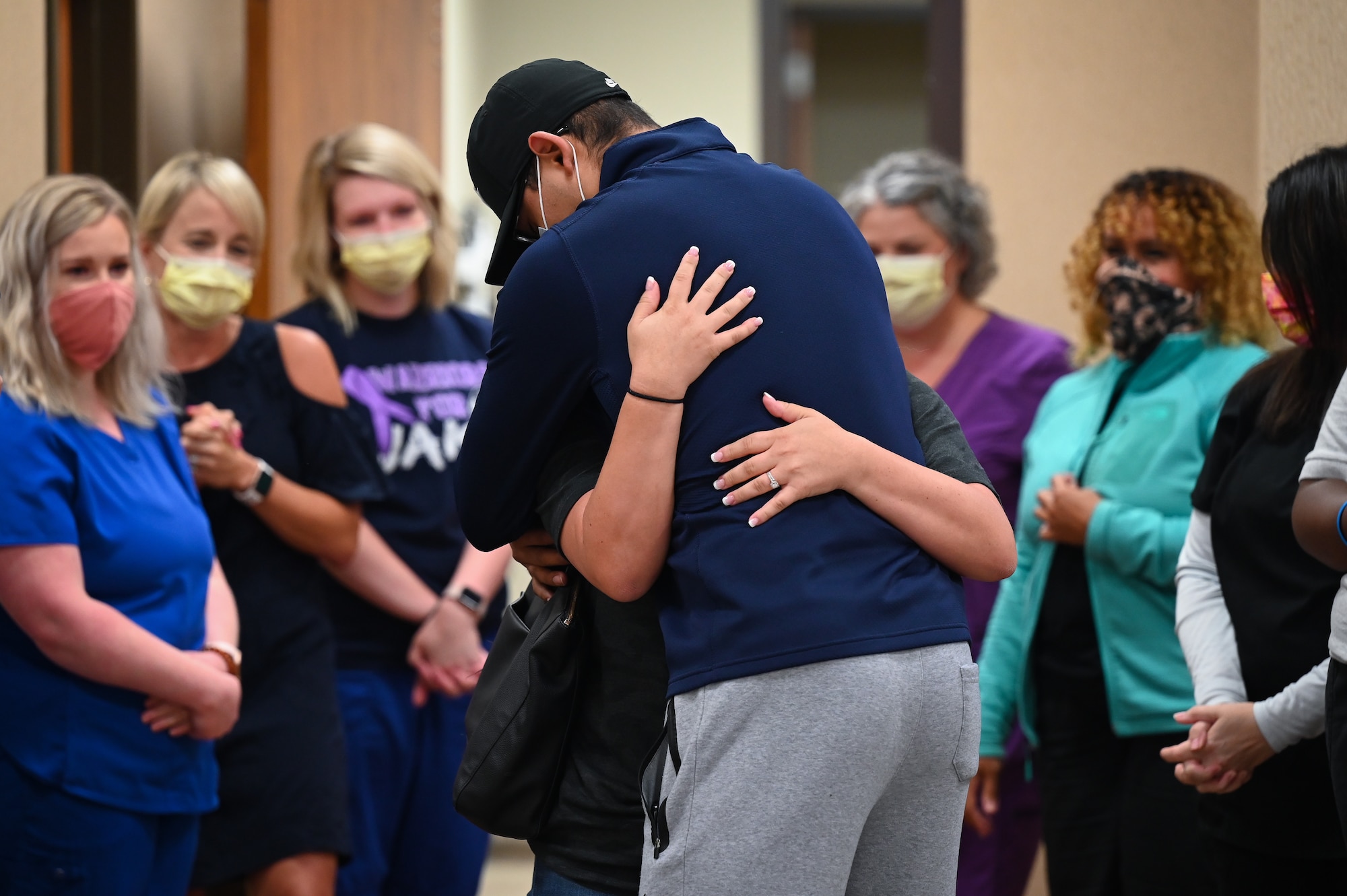 Senior Airman Eleazar Hernandez, 2nd Maintenance Squadron aerospace ground equipment journeyman, hugs his spouse after his final chemotherapy treatment at the CHRISTUS Health Shreveport-Bossier medical center, Louisiana, July 2, 2021. Hernandez fought cancer for 6 months before entering remission. (U.S. Air Force photo by Airman 1st Class Jonathan E. Ramos)