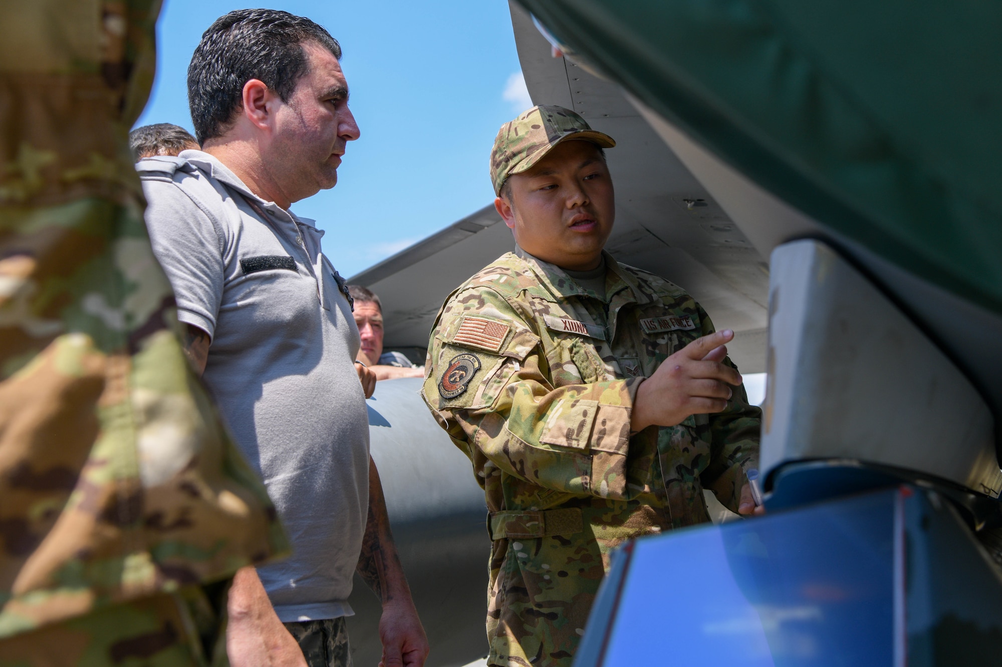 Senior Airman James Xiong, 31st Civil Engineer Squadron fire department driver operator, right, teaches Bulgarian air force members F-16 Fighting Falcon emergency response procedures during exercise Thracian Star 21 at Graf Ingatievo Air Base, Bulgaria, July 20, 2021. Participation in Thracian Star 21 offers an opportunity for Airmen to train and hone in on operational and tactical skills. (U.S. Air Force photo by Airman 1st Class Brooke Moeder)