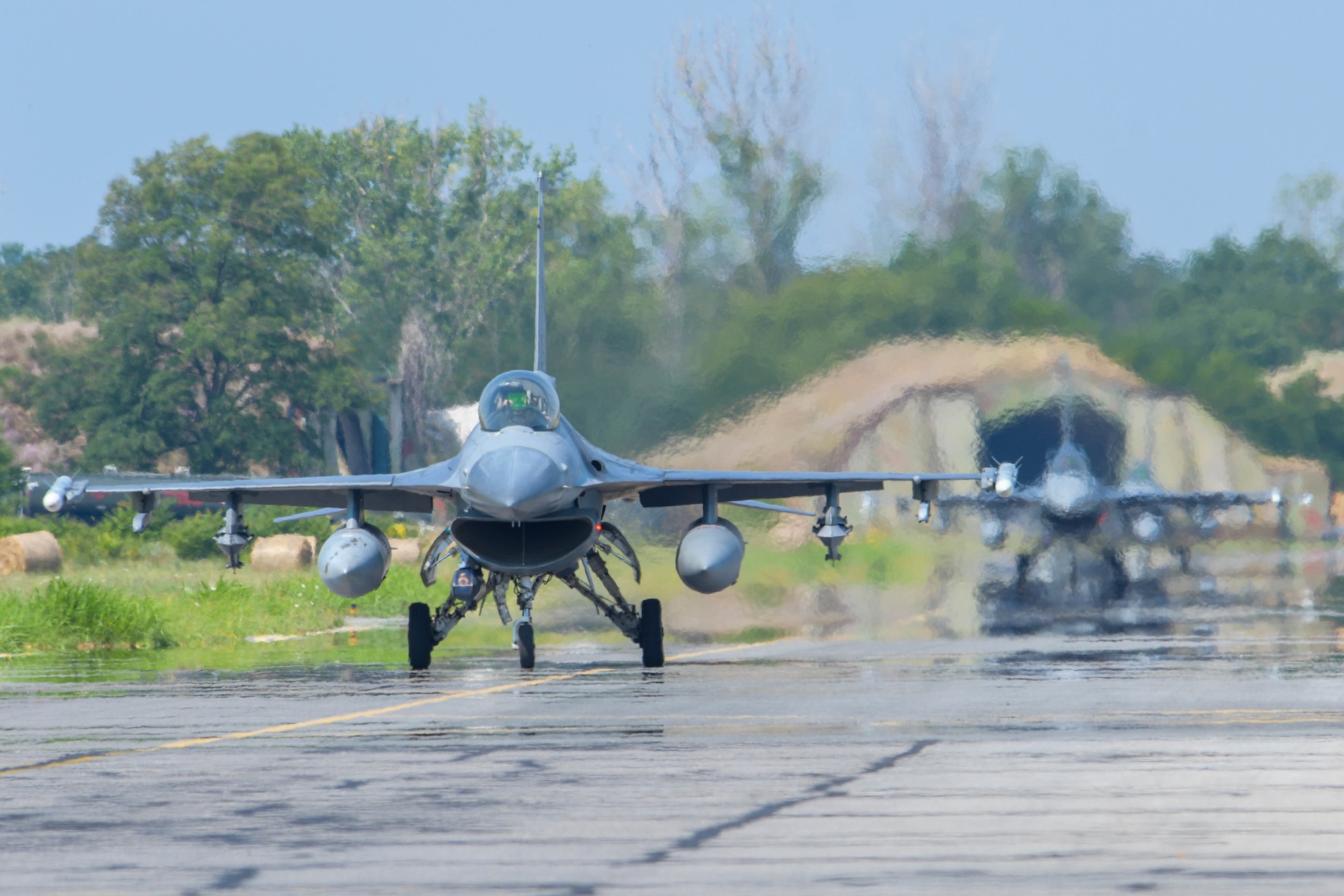 Two U.S. Air Force F-16 Fighting Falcons assigned to the 555th Fighter Squadron taxis on the flightline during Thracian Star 21 at Graf Ignatievo Air Base, Bulgaria, July 20, 2021. Eight F-16s assigned to the 555th FS participated in Thracian Star 21, a Bulgarian air force-led exercise aiming to enhance interoperability and the ability to rapidly deploy to remote locations. (U.S. Air Force photo by Airman 1st Class Brooke Moeder)