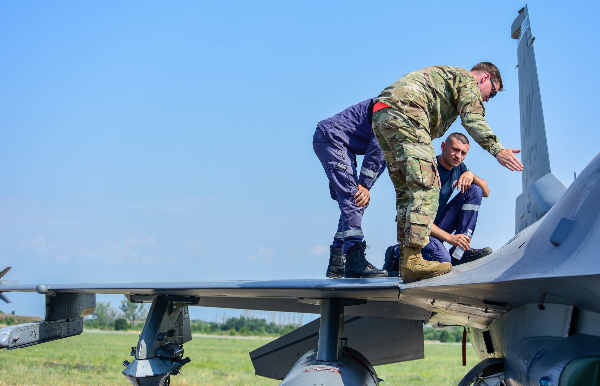 U.S. Air Force Staff Sgt. Jason Anders, 31st Maintenance Squadron aircraft fuels system craftsman, teaches Bulgarian air force members hydrazine emergency response procedures on a U.S. Air Force F-16 Fighting Falcon assigned to the 555th Fighter Squadron during exercise Thracian Star 21 at Graf Ignatievo Air Base, Bulgaria, July 20, 2021. This exercise required all levels of a squadron to deploy small teams of Airmen and aircraft for a short amount of time to hone their skills. Thracian Star 21 also enhanced their ability to rapidly deploy to a remote location, establish command and control and deliver lethal airpower more effectively and efficiently anywhere in the world. (U.S. Air Force photo by Airman 1st Class Brooke Moeder)