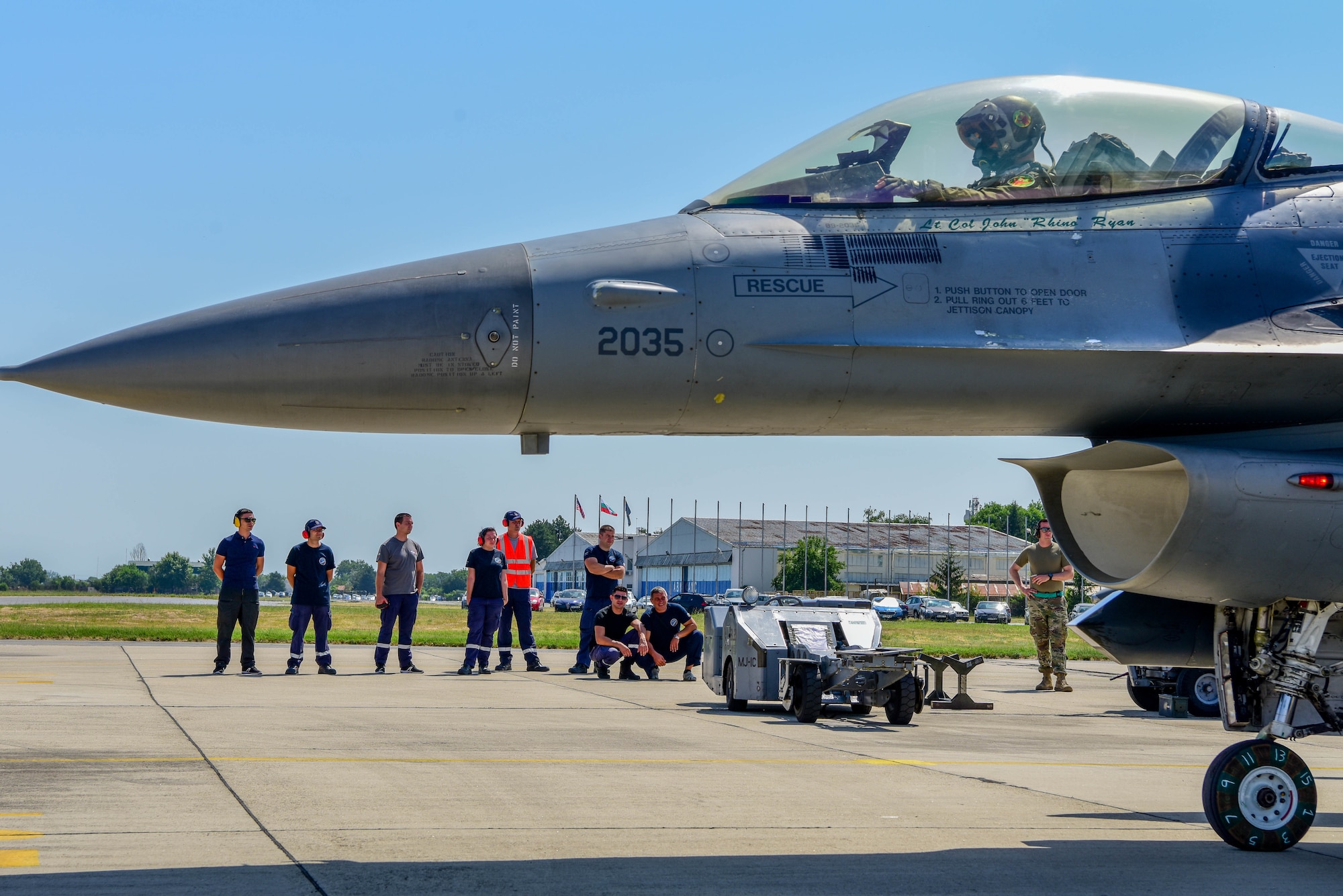 Bulgarian air force members watch an Integrated Combat Turnaround (ICT) demonstration during exercise Thracian Star 21 at Graf Ignatievo Air Base, Bulgaria, July 16, 2021. During the ICT, U.S. Air Force Airmen assigned to the 555th Aircraft Maintenance Unit worked together to load munitions while simultaneously refueling the aircraft, while the engine was running. (U.S. Air Force photo by Airman 1st Class Brooke Moeder)
