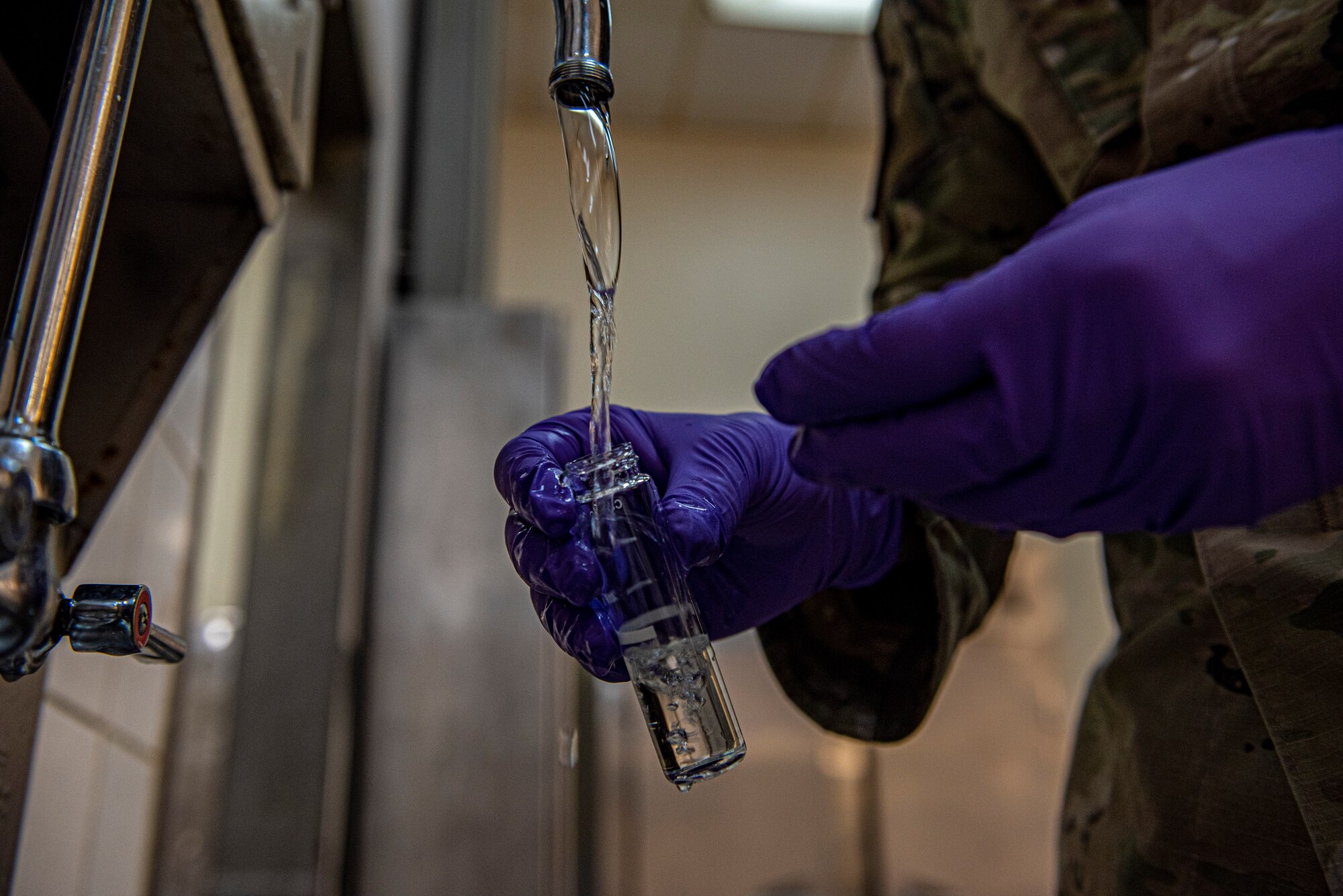 Senior Airman Matthew Ketterling, 379th Expeditionary Medical Operations Squadron bioenvironmental engineering journeyman, collects water samples at the Blachford-Preston Complex dining facility June 16, 2021, at Al Udeid Air Base, Qatar.