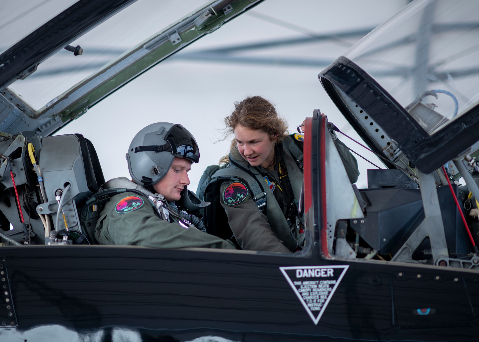 A pilot shows a crew chief controls inside a T-38 Talon