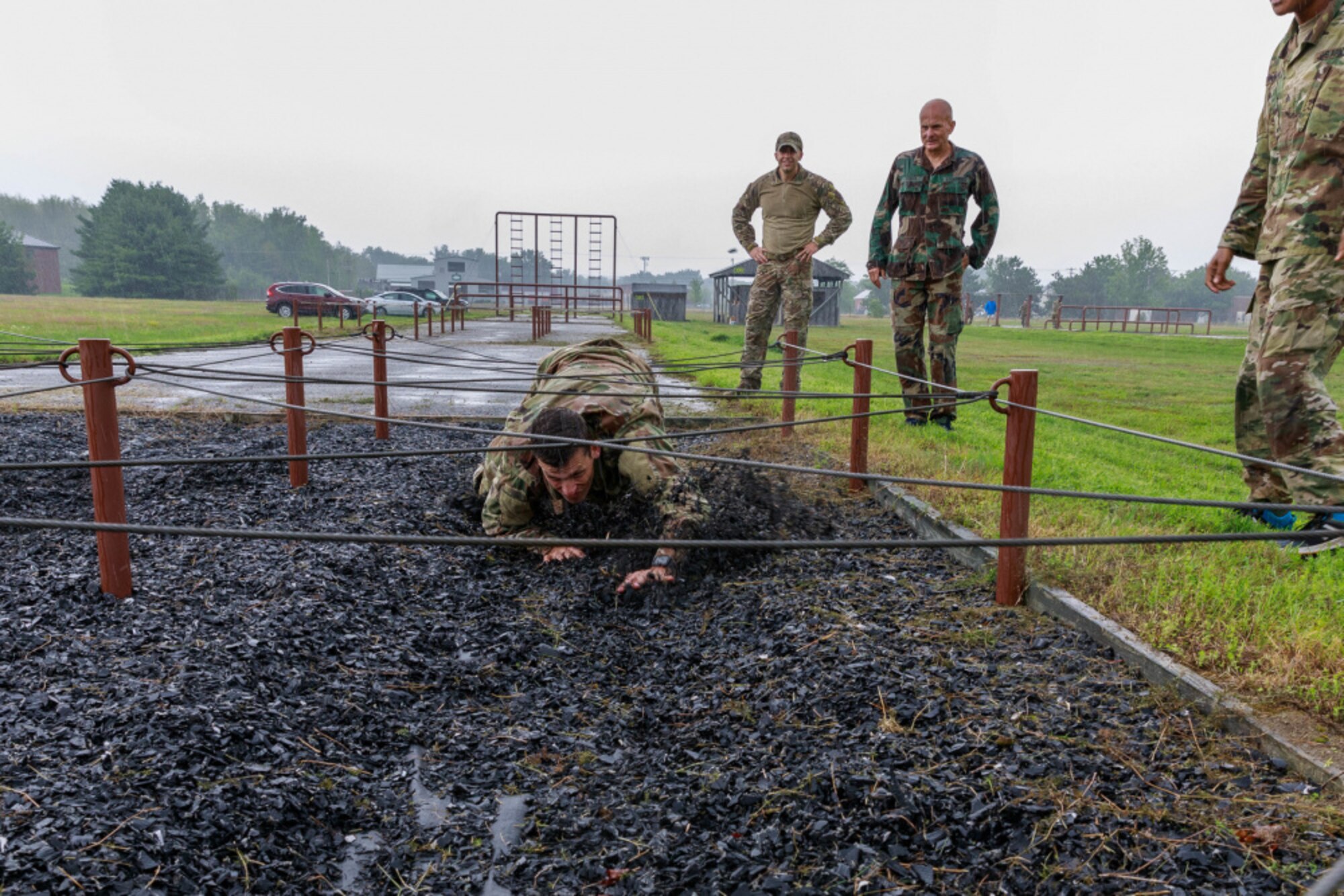 Senior Airman Trevor Thompson, a reservist in the 67th Aerial Port Squadron, navigates under an obstacle on the land obstacle course at Camp Johnson, Vermont as part of the team selection and training event