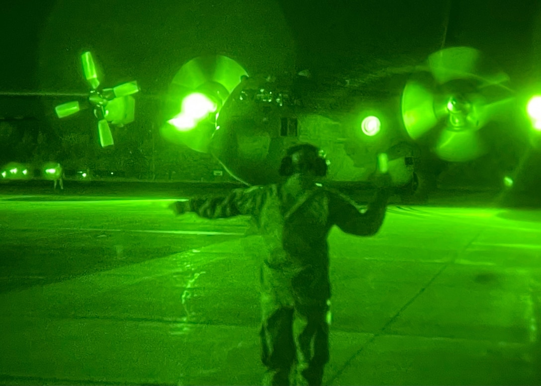 An Airman from the Puerto Rico Air National Guard’s 156th Contingency Response Group marshals a C-130 Hercules aircraft using night-vision equipment at Muñiz Air National Guard Base in Carolina, Puerto Rico, on June 15, 2021, as part of Maintenance University. More than 130 Airmen from the Kentucky Air Guard’s 123rd Airlift Wing trained on career-specific proficiencies during the intensive course, joining with members of the Puerto Rico Air Guard for night-vision training. (U.S. Air National Guard photo by Staff Sgt. Clayton Wear)