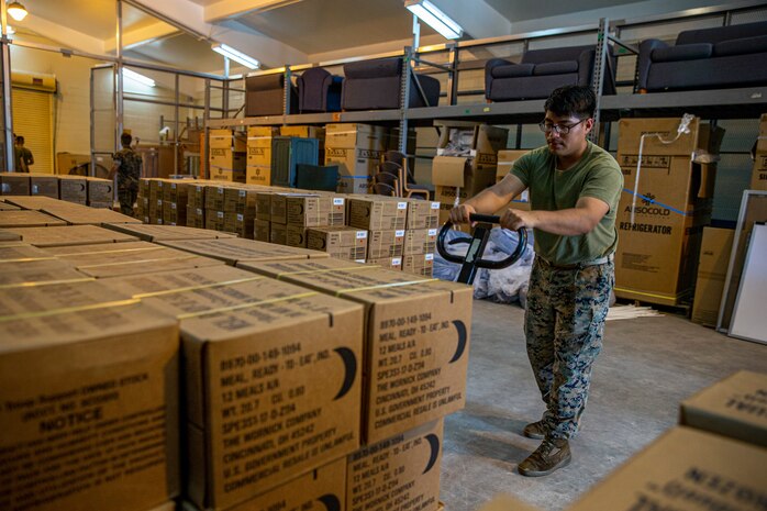 U.S. Marine Corps Lance Cpl. Edwin Carino, a distribution management specialist with Headquarters and Support Battalion, Marine Corps Installations Pacific, transports meals, ready to eat (MRE’s) on Camp Lester, Okinawa, Japan, July 19, 2021. In preparation for Typhoon In-Fa, Camp Foster Camp Services provide units with MRE’s, base preparation services, sandbags, and bulk trash storage to keep service members safe and prepared during typhoon season in Okinawa. Carino is a native of Rariden, New Jersey. (U.S. Marine Corps photo by Lance Cpl. Alex Fairchild)