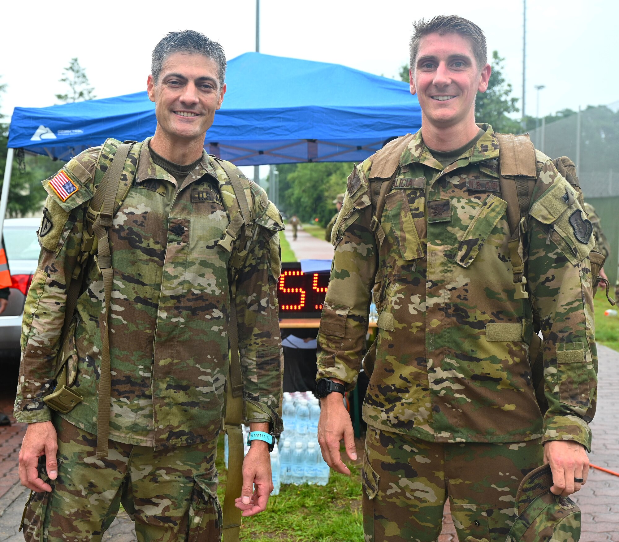 Lt. Col. Eric Palicia (left), United States Army Europe and Africa deputy facilities and construction chief, stands next to his brother U.S. Air Force Maj. Noah Palicia (right), 86th Airlift Wing Commander’s Action Group chief, at Ramstein Air Base, Germany, July 16, 2021. The brothers were the first to finish the 6th Annual Chief Master Sgt. of the Air Force Paul Airey Memorial Ruck with a time of 45 minutes. (U.S. Air Force photo by Senior Airman Thomas Karol)