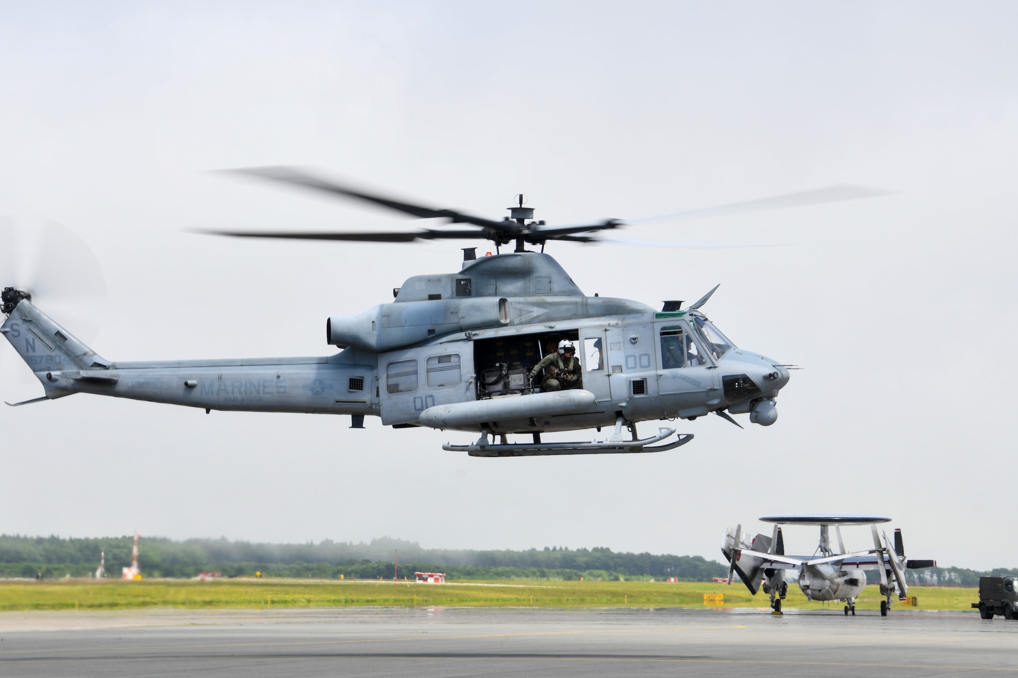 a helicopter hovers above pavement