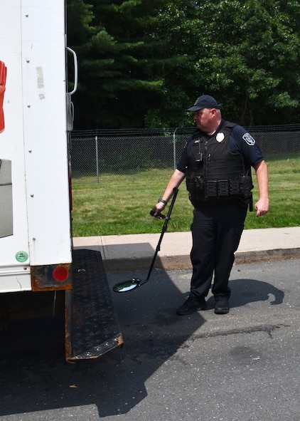 Officer Robert Keeler, 104th Fighter Wing Installation Security Officer, inspects a commercial vehicle looking for contraband July 21, 2021, at Barnes Air National Guard Base, Massachusetts. Keeler works with other civilian officers and military defenders to ensure safety on base.  (U.S. Air National Guard photo by Staff Sgt. Sara Kolinski)