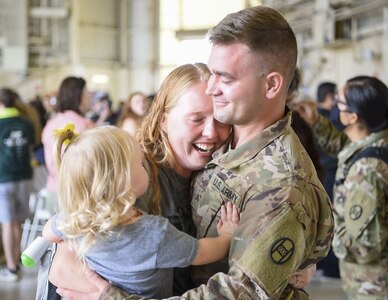 A Soldier with North Carolina National Guard’s 30th Armored Brigade Combat Team reunites with his family Aug. 15, 2020, in Charlotte, N.C. The Soldiers returned home after a year-long deployment to the Middle East in support of Operation Inherent Resolve and Operation Spartan Shield.