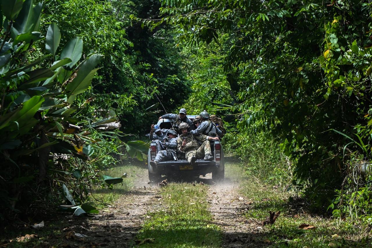 Soldiers ride in a vehicle.