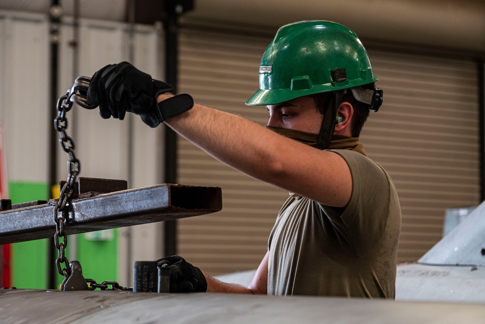 Photo of airman working on external fuel tank