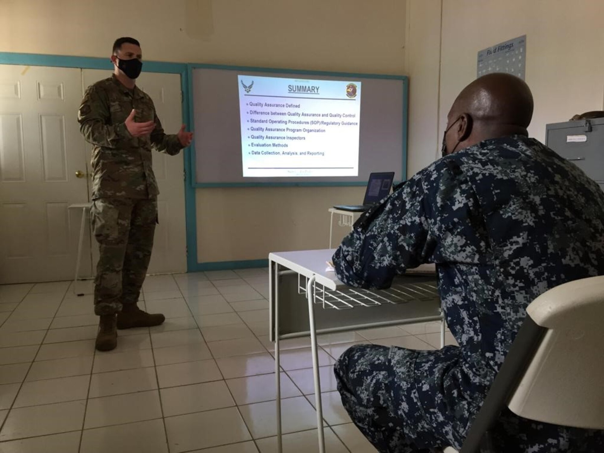 Tech. Sgt. Jacob Haines, 571st Mobility Support Advisory Squadron air advisor, discusses aircraft maintenance quality assurance fundamentals with Maj. Gladstone Allen, Jamaican Defense Force Air Wing training and standards officer, June 15, 2021, in Kingston, Jamaica. Air advisors train and assist partner nations in developing air mobility capabilities through Mobile Training Team engagements. (Courtesy photo)