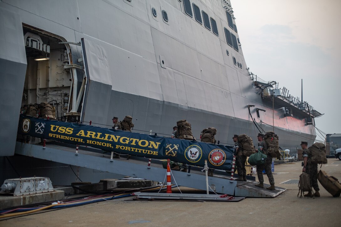 U.S. Marines and Sailors with Combat Logistics Battalion 22 arrive aboard the USS Arlington (LPD-24) during Defense Support of Civil Authorities (DSCA) mission rehearsals at Naval Base Norfolk, Virginia, July 21, 2021. Marines and Sailors with the II Marine Expeditionary Force Maritime DSCA Task Force, commanded by Combat Logistics Battalion 22, and Sailors aboard the USS Arlington conducted a destructive weather mission rehearsal loading exercise to prepare and rehearse for a future DSCA mission during the 2021 hurricane season. (U.S. Marine Corps photo by Lance Cpl. Scott Jenkins)