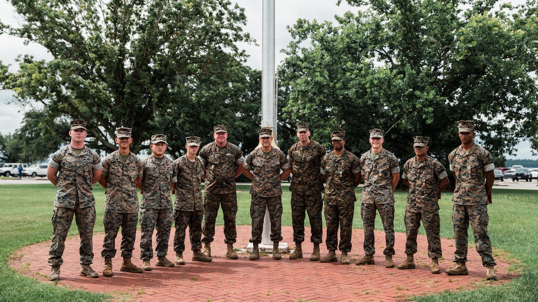 U.S. Marines with Headquarters Battalion (HQBN) and 2d Combat Engineer Battalion (CEB) pose for a photo with the 2d Marine Division commanding staff at Camp Lejeune, N.C., July 21, 2021. Marines with HQBN and 2d CEB were awarded the Navy and Marine Corps Achievement Medal for their superior performance for their efforts during the five-day High Frequency Radio competition. (U.S. Marine Corps photo by Cpl. Patrick King)