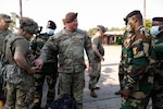 Sgt. 1st Class Jamie Vincent explains the use of Multiple Integrated Laser Engagement System gear to visiting Senegalese soldiers at the Joint Readiness Training Center in Fort Polk, Louisiana, July 22, 2021.