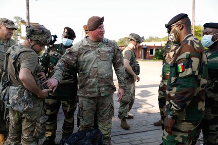 Sgt. 1st Class Jamie Vincent explains the use of Multiple Integrated Laser Engagement System gear to visiting Senegalese soldiers at the Joint Readiness Training Center in Fort Polk, Louisiana, July 22, 2021.