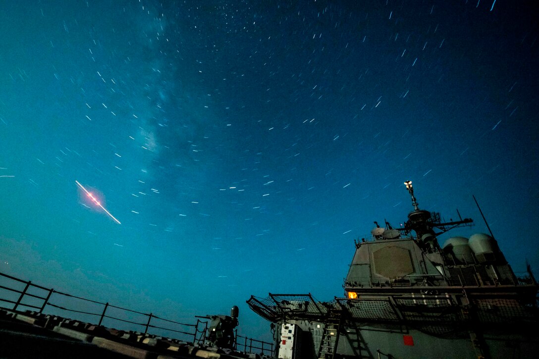 A  part of a ship is seen under a dark, starry sky.