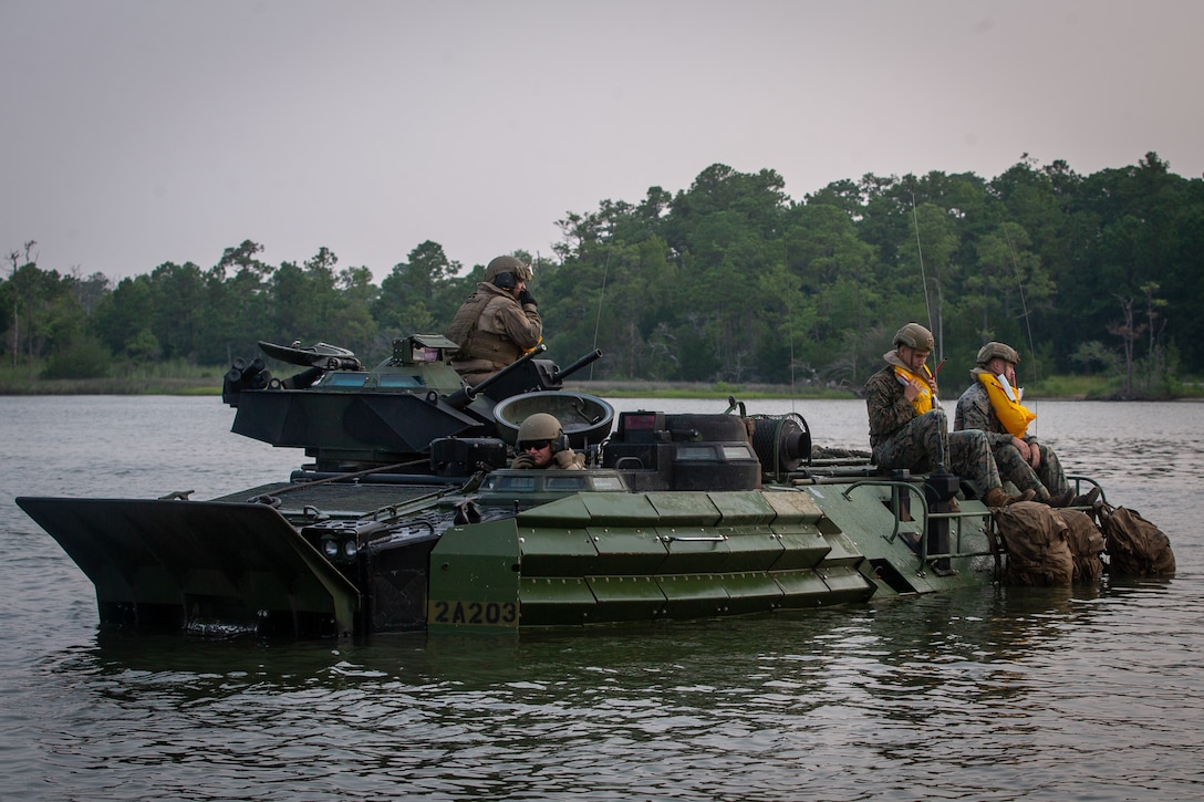 U.S. Marines with 2d Assault Amphibian Battalion (AABn.), 2d Marine Division (MARDIV), instruct Marines and Sailors with 1st Battalion, 2d Marine Regiment, (1/2) 2d MARDIV on the proper use of safety equipment during a mechanized amphibious egress exercise on Camp Lejeune, N.C., July 22, 2021. The exercise improves how 1/2 integrates with 2d AABn. and prepares the unit for future conflict by strengthening its naval expeditionary capabilities. (U.S. Marine Corps photo by Lance Cpl. Brian Bolin Jr.)