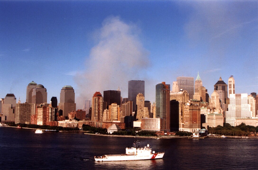 The World Trade Center complex continues to burn, while the Coast Guard Cutter Tahoma controls vessel traffic in New York harbor September 15.