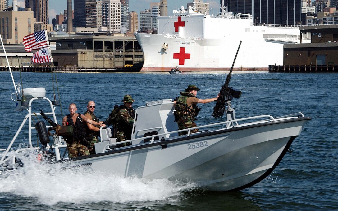 "A Coast Guard Port Security boat races to question a recreational vessel on the Hudson River in New York. Coast Guard vessels are deployed around Manhattan to ensure the safety of New York city's waterways."; 19 September 2001; CG# 010910-C-9409S-501 (FR); photo by PA2 Tom Sperduto.