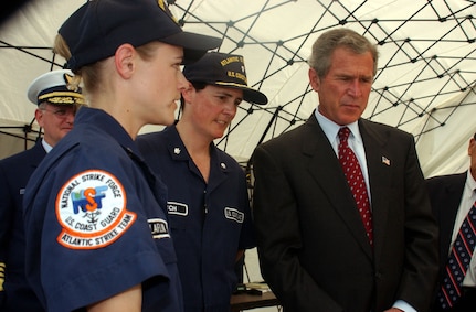 Members of Coast Guard Strike Team, Petty Officer 2rd class Tina Claflin and Cdr. Gail Kulisch gives President Bush a tour of the Strike Team tent.