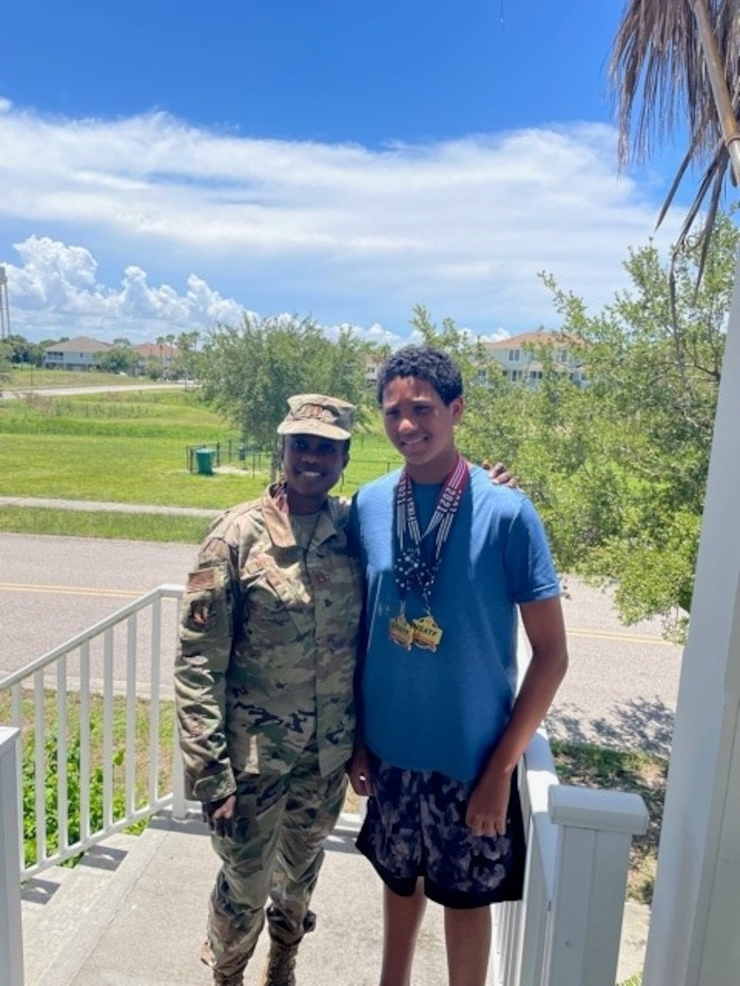 U.S. Air Force Captain Florentine Hiestand, left, a nurse at the 6th Medical Group, MacDill Air Force Base, Florida, stands next to her son, Benjamin Hiestand, a student at Tinker K-8 School, with his two first-place medals that he won during the United States of America Track and Field Youth Nationals in Rome, Georgia, June 2021. Hiestand’s winning shot put was 41 feet, 4 inches and winning discus throw was 109 feet, 7 inches. (Courtesy photograph)