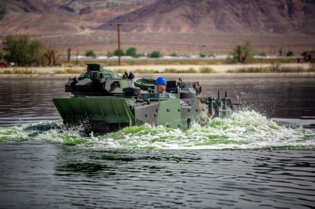 U.S. Marine Corps Staff Sgt. Erick Moates, motor transport operator, goes for a test run in an AAVP-7A1 Assault Amphibious Vehicle at the vehicle test track of Production Plant Barstow on Marine Corps Logistics Base Barstow, California, July 22, 2021. (U.S. Marine Corps photo by Jack J. Adamyk)