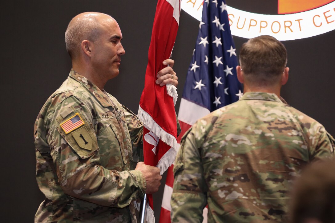 Maj. Gen. Jeffrey L. Milhorn, right, deputy commanding general for military and international operations of the U.S. Army Corps of Engineers, presents Huntsville Center’s colors to Col. Sebastien P. Joly during a change of command ceremony at Bob Jones Auditorium on Friday, July 23. (Photo by Michael May)