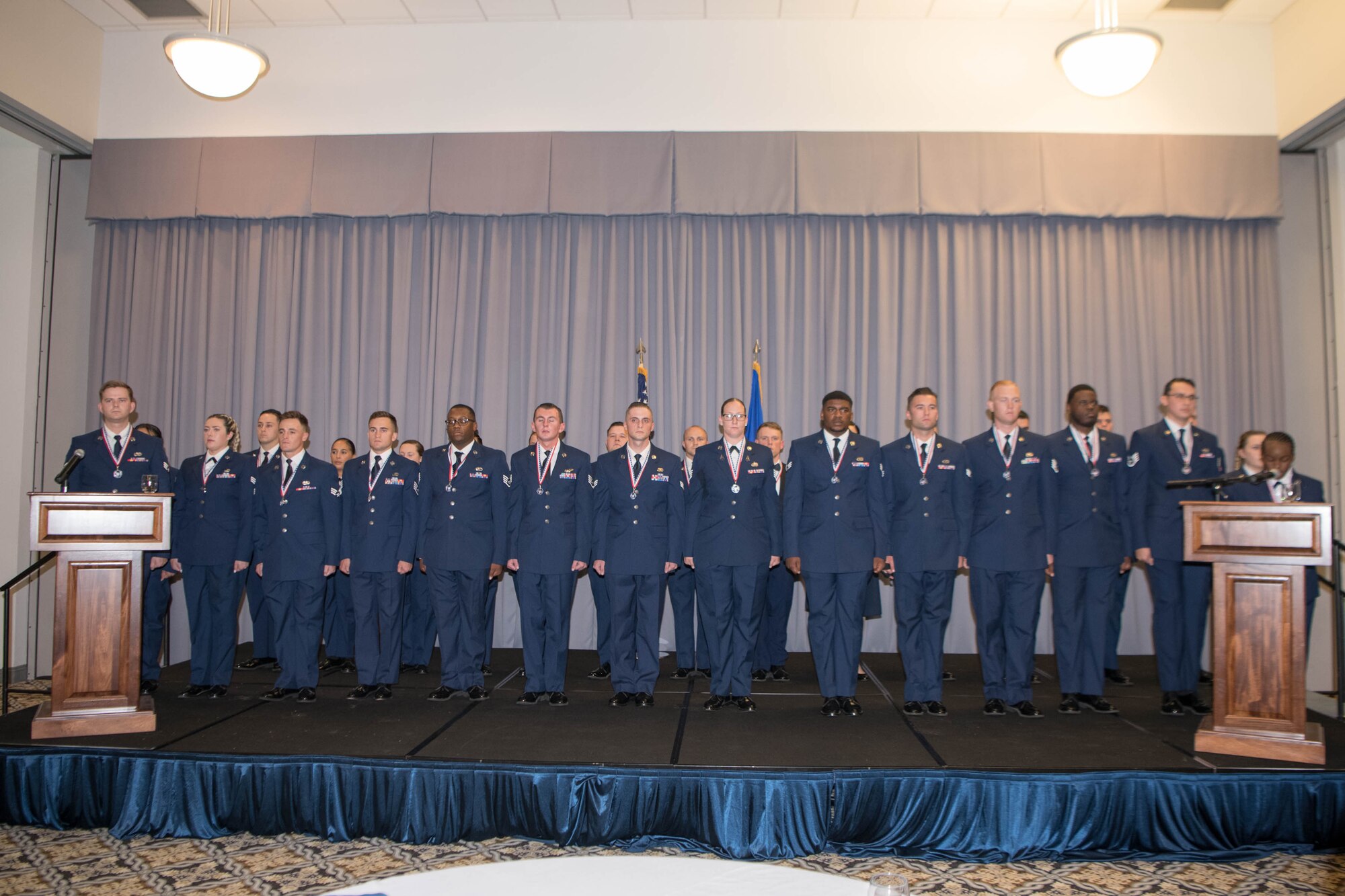 Graduates of the Staff Sgt. Julio Alonso Airman Leadership School, Class 21-F, recite the Airman’s Creed during their graduation ceremony held at The Landings on Dover Air Force Base, Delaware, July 22, 2021. Twenty-nine Airmen graduated at the first post-COVID-19 dinner and graduation ceremony. (U.S. Air Force photo by Mauricio Campino)