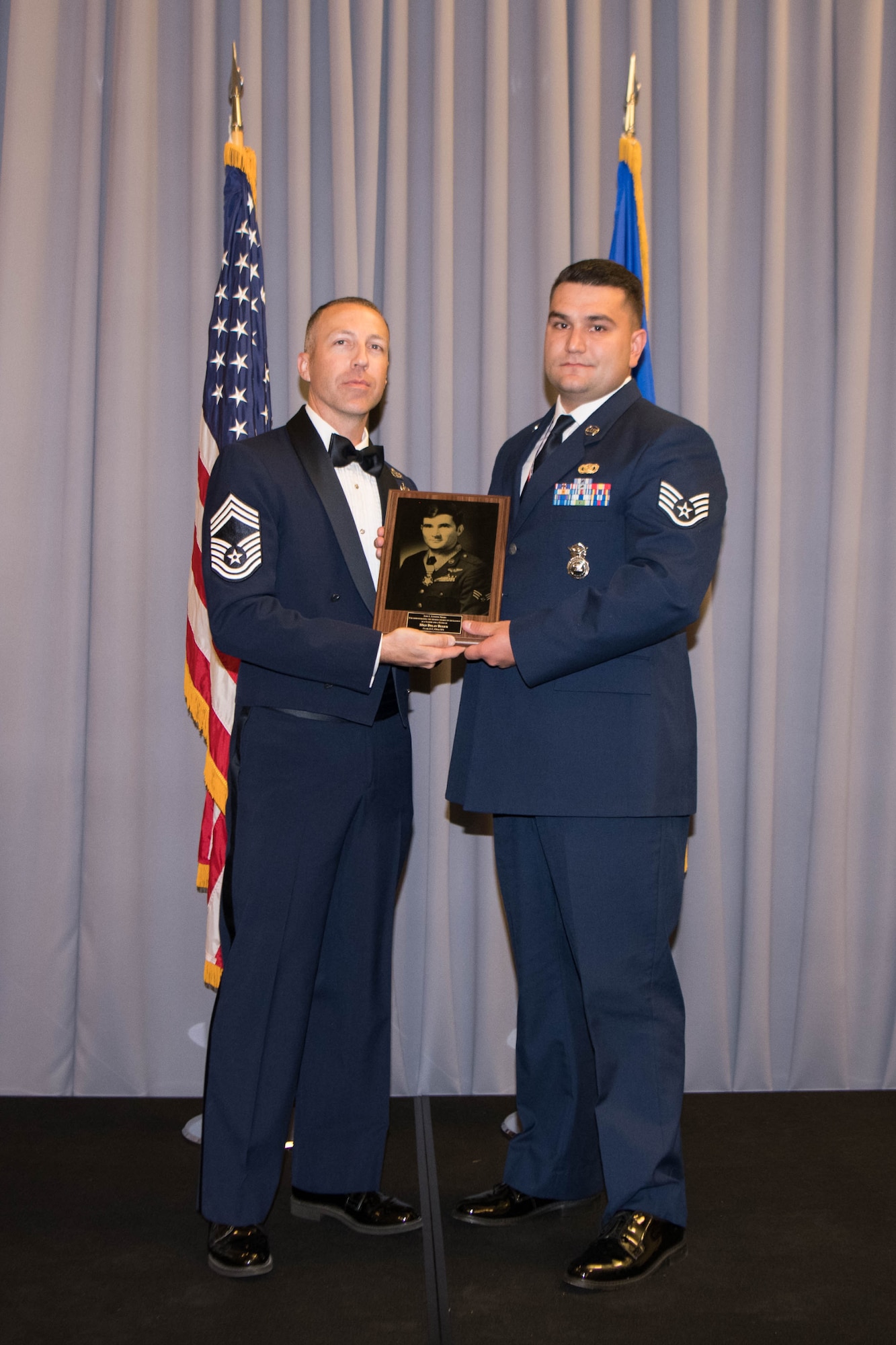 Staff Sgt. Dylan Bulick, 436th Security Force Squadron base defense operations center controller, is presented the John L. Levitow Award by Chief Master Sgt. Troy Dubois, 436th Logistics Readiness Squadron superintendent, during the Staff Sgt. Julio Alonso Airman Leadership School, Class 21-F, dinner and graduation ceremony held at The Landings on Dover Air Force Base, Delaware, July 22, 2021. This was the first post-COVID-19 dinner and graduation ceremony held since February 6, 2020. (U.S. Air Force photo by Mauricio Campino)