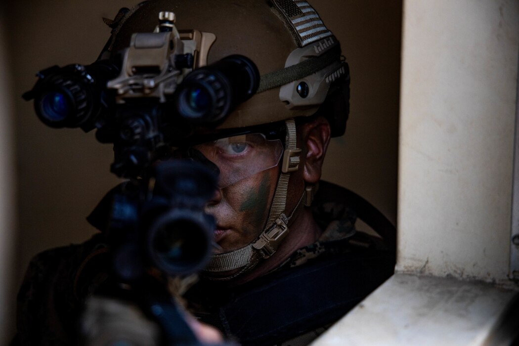 A U.S. Marine, assigned to 1st Battalion, 1st Marine Regiment, 1st Marine Division, looks through the sights of an M4 carbine on May 25, 2021 at Camp Pendleton, California. Marines with the 11th Marine Expeditionary Unit conducted an amphibious assault as one of the culminating events for pre-deployment training.