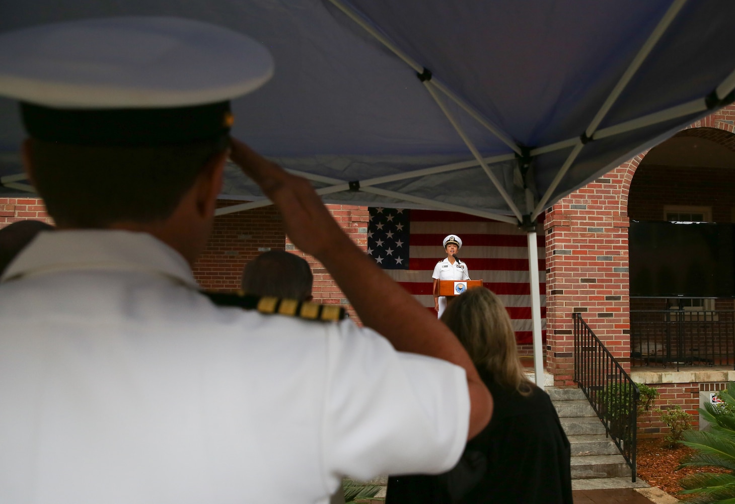 Lt. Cmdr. Kimi Schultheiss sings the national anthem during the Naval Education and Training Command (NETC) 50th anniversary ceremony at Naval Air Station Pensacola.  NETC, led by Rear Adm. Pete Garvin, is the U.S. Navy’s Force Development pillar and largest shore command.  Through its “Street to Fleet” focus, NETC recruits civilians and transforms them into skilled warfighters ready to meet the current and future needs of the U.S. Navy.