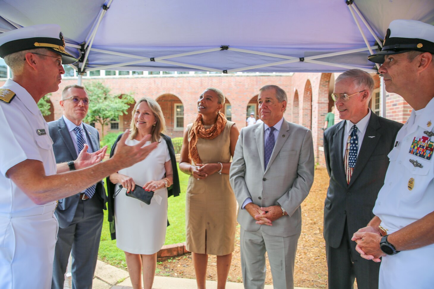 Rear Adm. Pete Garvin, commander, Naval Education and Training Command (NETC), left, and Force Master Chief Matthew Harris, right, speak with former NETC commanders and force master chiefs to celebrate NETC's 50th anniversary after a ceremony at Naval Air Station Pensacola.  NETC is the U.S. Navy’s Force Development pillar and largest shore command.  Through its “Street to Fleet” focus, NETC recruits civilians and transforms them into skilled warfighters ready to meet the current and future needs of the U.S. Navy.