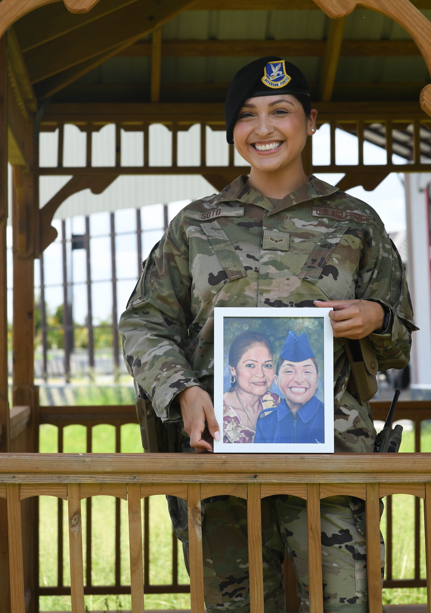 Airman 1st Class Jocelyn Soto holds a painting of her and her mother.