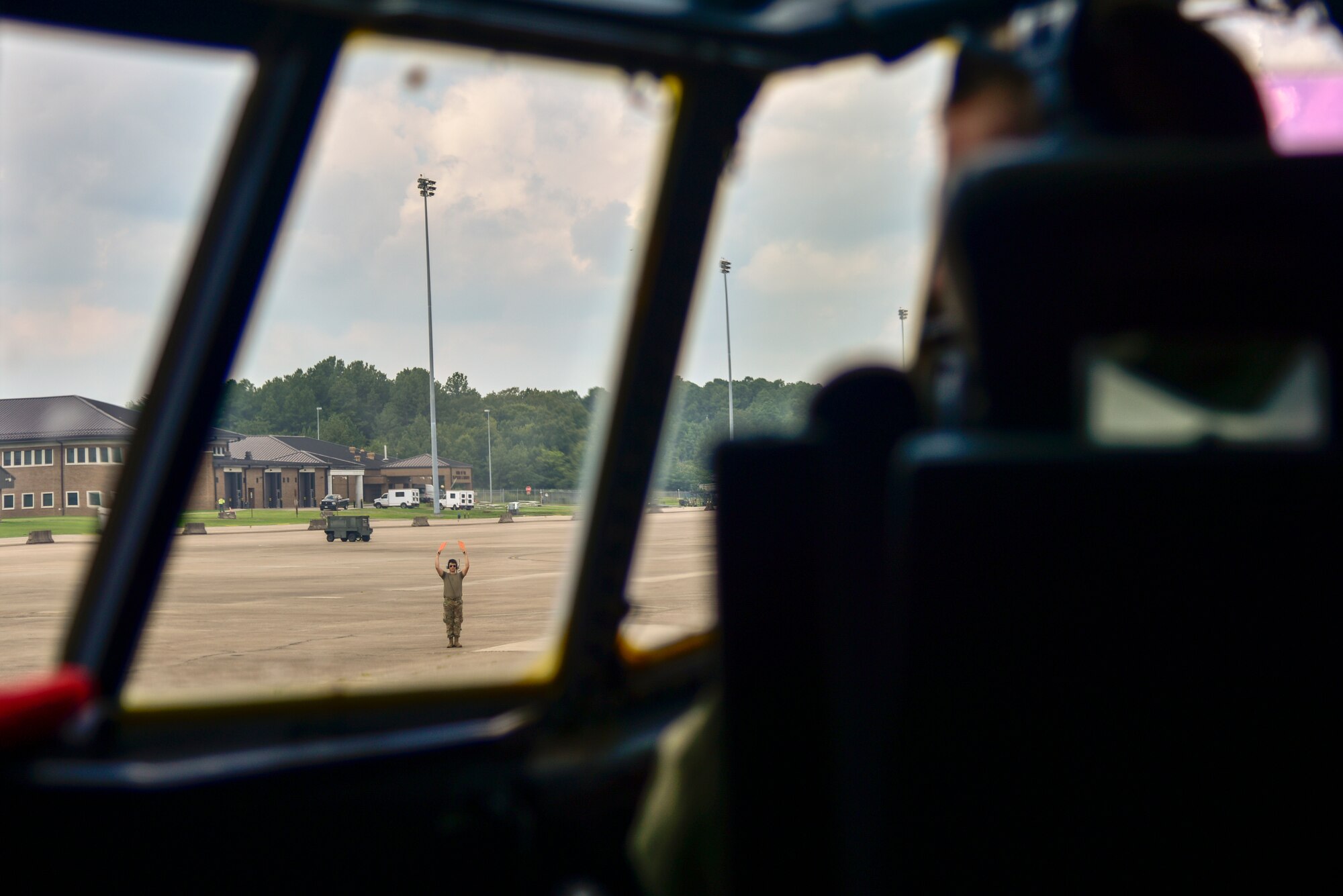Airman marshals out a C-130.