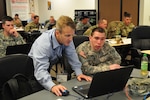 Kenneth Frische, Director of Cybersecurity at Ultra Electronics and an instructor at Cyber Shield 17, steps in to help U.S. Army Staff Sgt. Kelement of the Colorado National Guard during class at Camp Williams, Utah, April 26, 2017. Cyber Shield is a National Guard exercise designed to assess Soldiers, Airmen, and civilian personnel on response plans to cyber incidents (U.S. Army National Guard photo by Staff Sgt. Bethany Anderson)