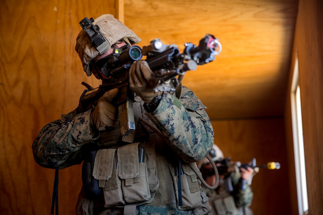 A Marine with Lima Company, 3rd Battalion, 4th Marine Regiment, provides security from inside a compound during a Marine Corps Combat Readiness Evaluation at Marine Corps Air Ground Combat Center Twentynine Palms, Calif., Feb. 26, 2017. MCCREs are conducted to ensure unit standardization and combat readiness in preparation for operational deployments. (U.S. Marine Corps photo by Lance Cpl. Joseph Prado)