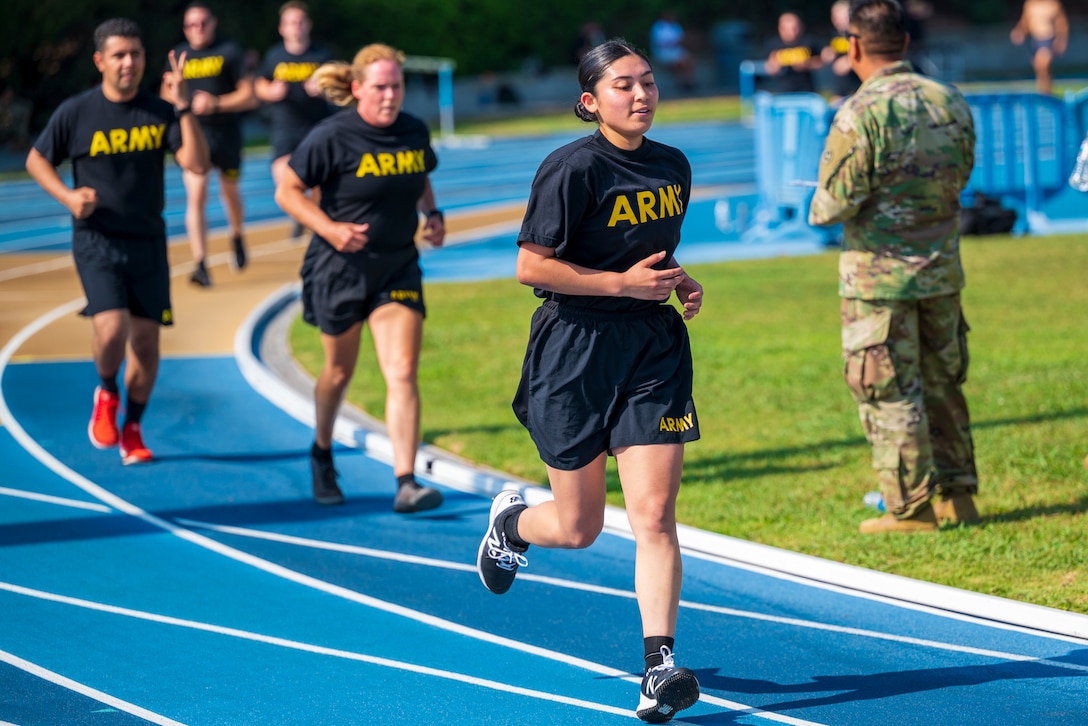 Soldiers run on a track.