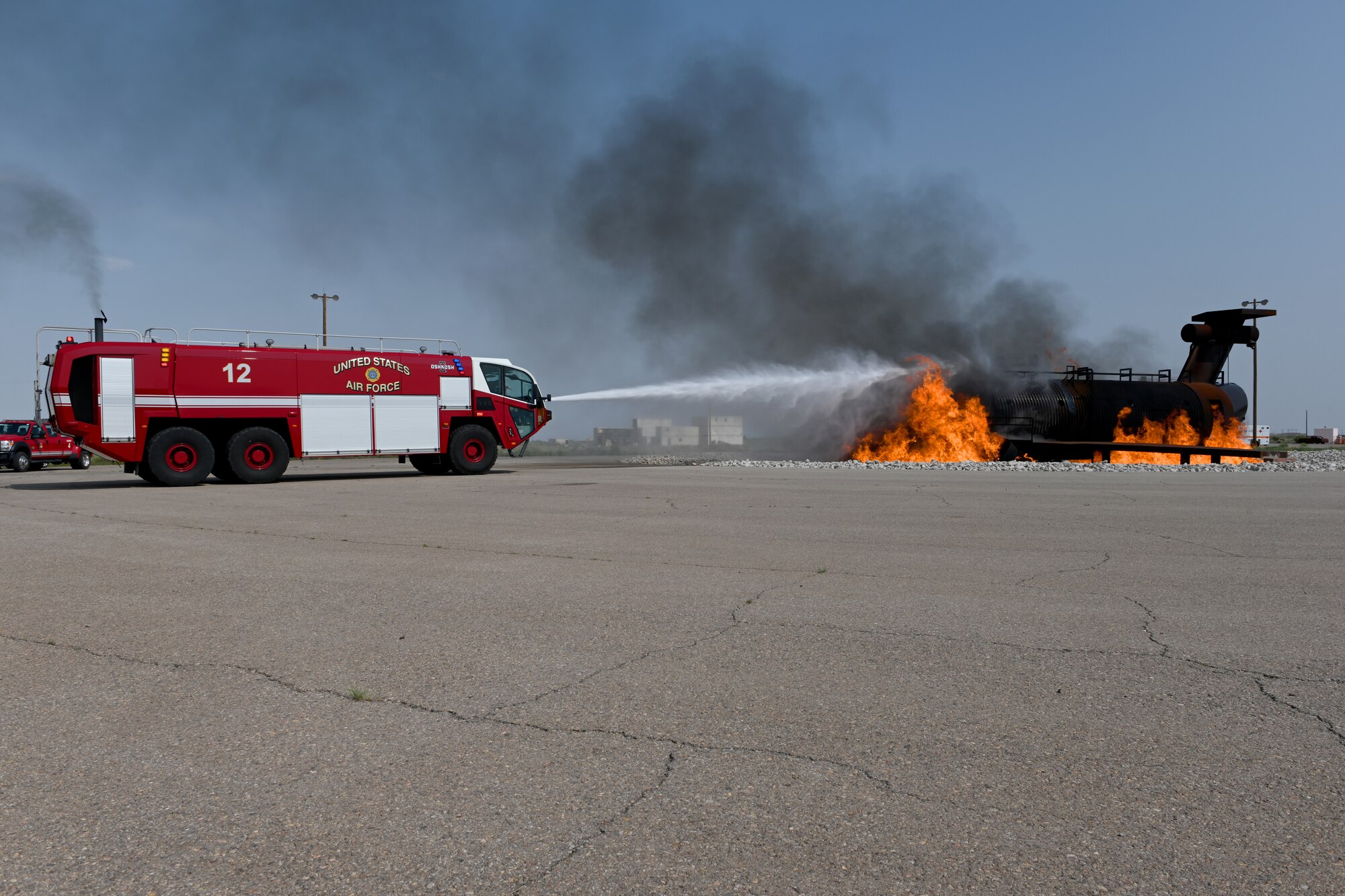 Chief Master Sgt. Kristina Rogers, 19th Air Force command chief, extinguishes a simulated aircraft fire, July 21, 2021, on Holloman Air Force Base, N.M. During the visit, the command team visited locations including the 16th Training Squadron, Holloman Airman Leadership School and the 49th Civil Engineer Squadron. (U.S. Air Force photo by Staff Sgt. Christopher S. Sparks)