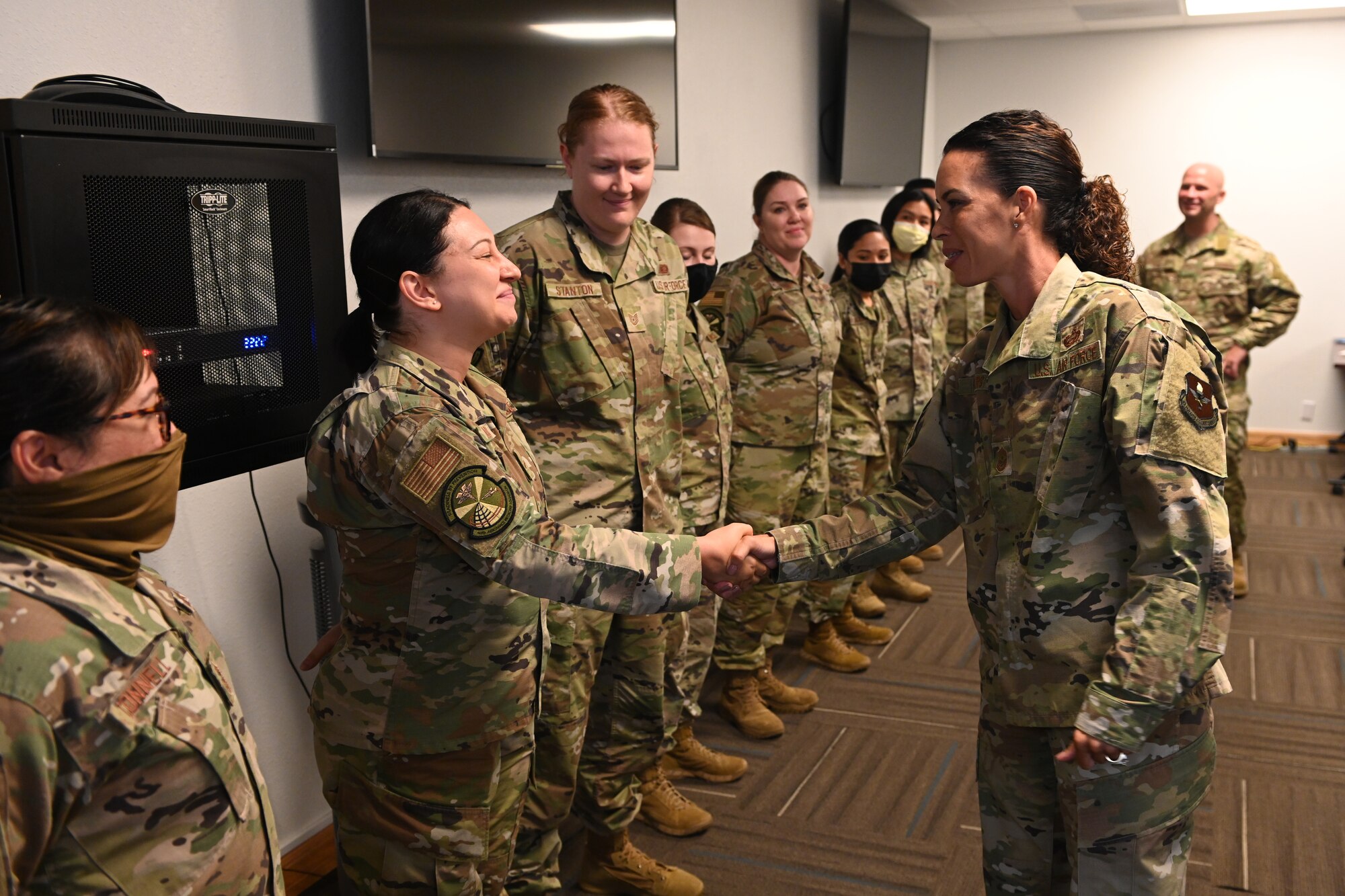 Chief Master Sgt. Kristina Rodgers, 19th Air Force command chief, coins a 49th Medical Group Airman July 21, 2021, on Holloman Air Force Base, N.M. The visit served as an opportunity for the 19th AF command team to learn how 49th Wing Airmen execute the mission and provided an opportunity for them to recognize superior performers. (U.S. Air Force photo by Staff Sgt. Christopher S. Sparks)