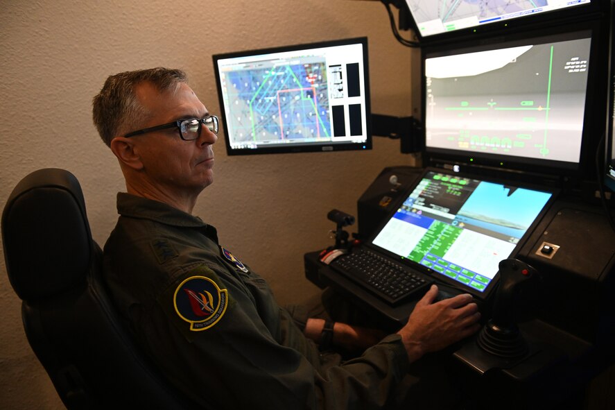 Maj. Gen. Craig D. Wills, 19th Air Force commander, flies an MQ-9 Reaper simulator, July 20, 2021, on Holloman Air Force Base, N.M. The command team held three all-calls with the wing, and spoke on the importance of training, readiness and how our Airmen give the U.S. Air Force a competitive edge in our fight against U.S. adversaries. (U.S. Air Force photo by Staff Sgt. Christopher S. Sparks)