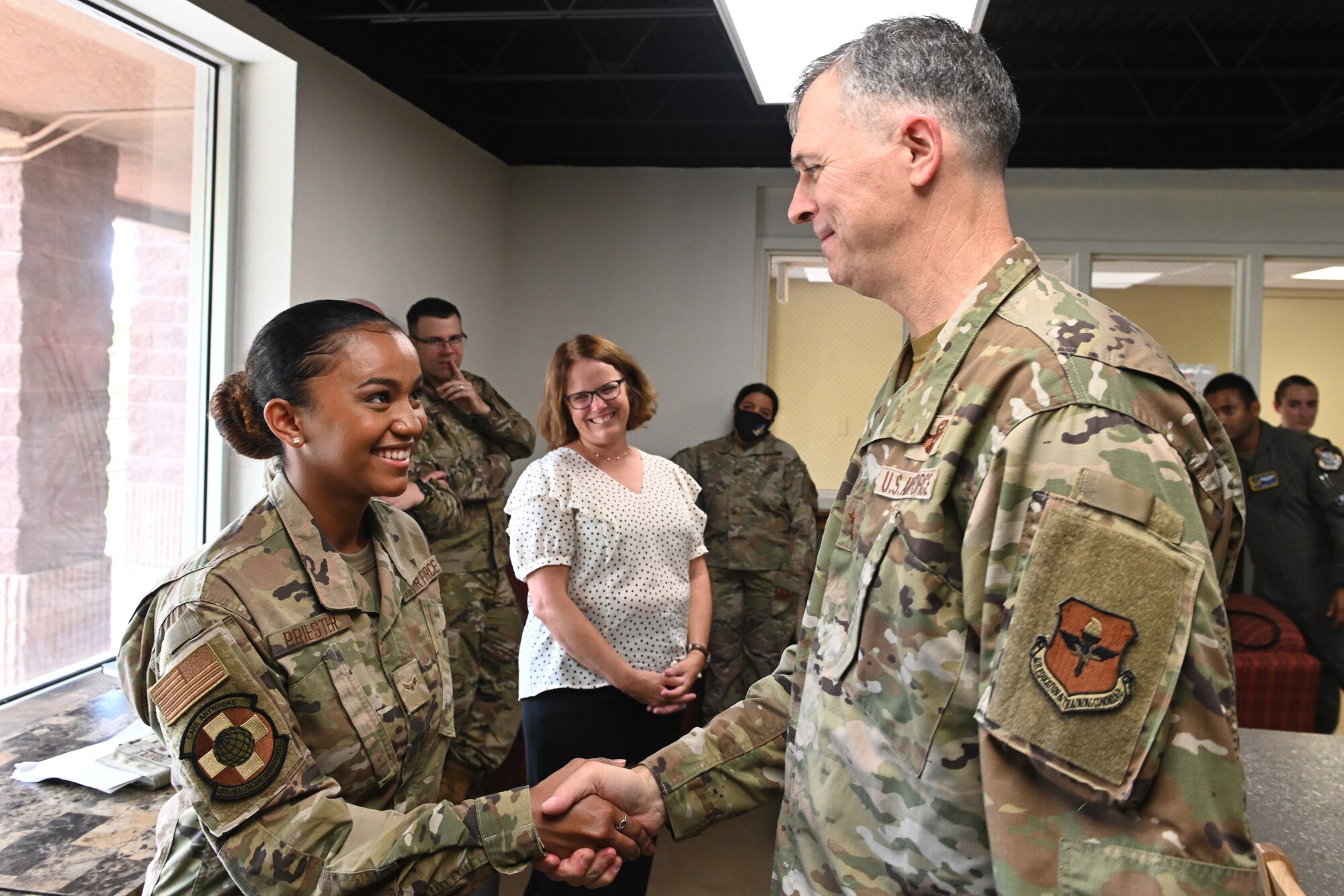 Maj. Gen. Craig D. Wills, 19th Air Force commander, coins a 49th Wing dorm resident advisor July 20, 2021, on Holloman Air Force Base, N.M. The Dorm RA council is the first of its kind in the Air Education Training Command. (U.S. Air Force photo by Staff Sgt. Christopher S. Sparks)